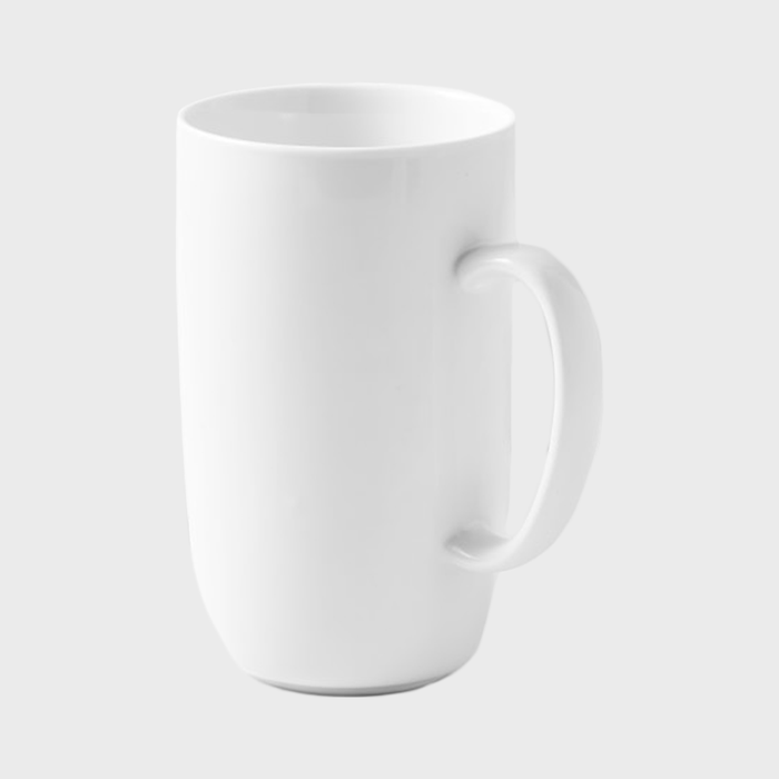 A plain white mug stands upright on a featureless gray background.