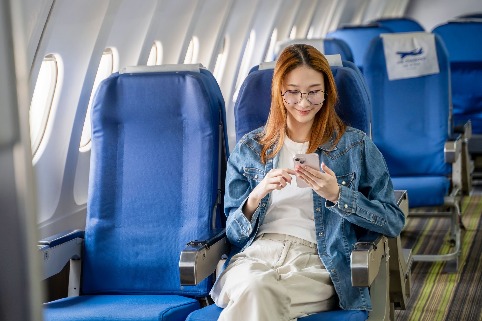 Women Sitting On Airplane Seat