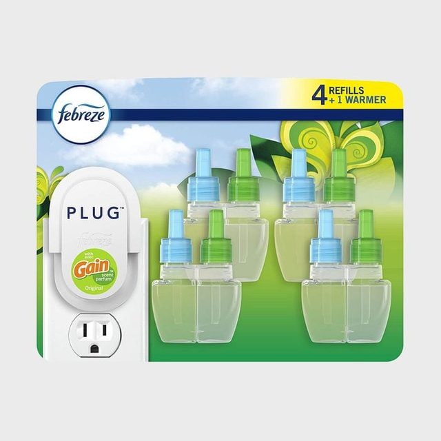 Air freshener plug-in set includes one warmer and four refills. Background shows leafy patterns and blue sky. Text: 