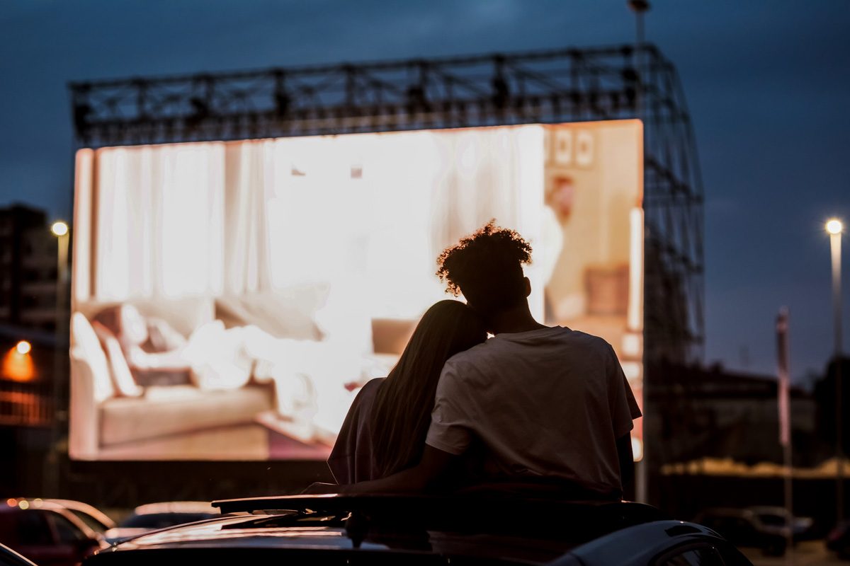 110 Romantic And Fun Date Ideas To Spark A Connection - couples watching a drive-in movie