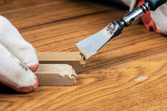Common Mistake Can Ruin Your Floors This Winter - repairing wooden floor using wax strip