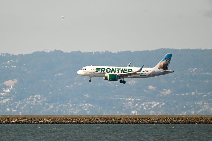 Frontier aiplane landing on a runway