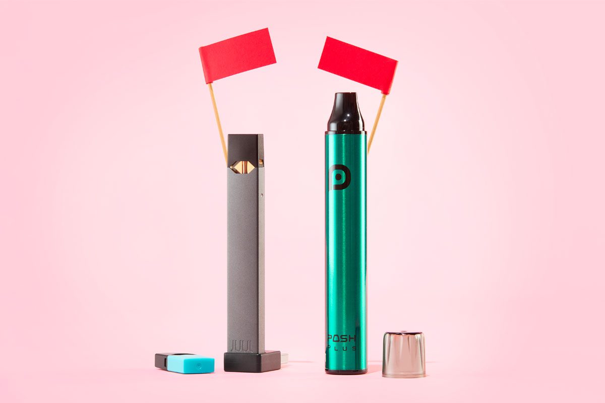 two e-cig vapes with red flags on a pink background