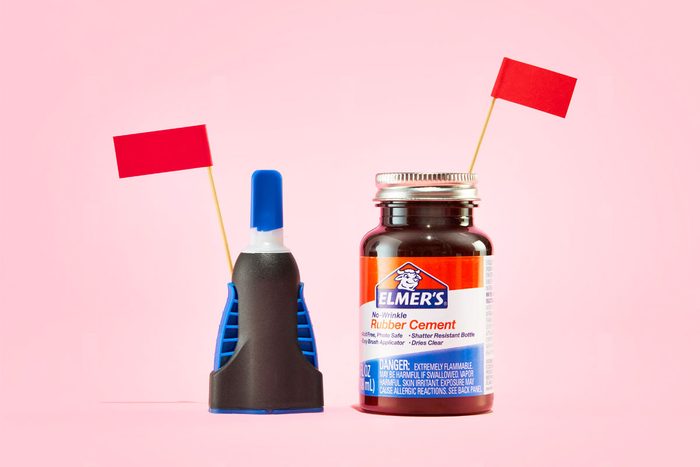 flammable specialty glue with red flags against a pink background