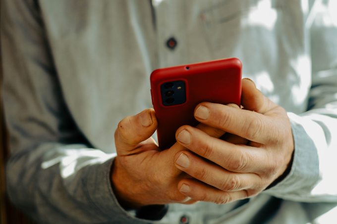 Person holding red phone