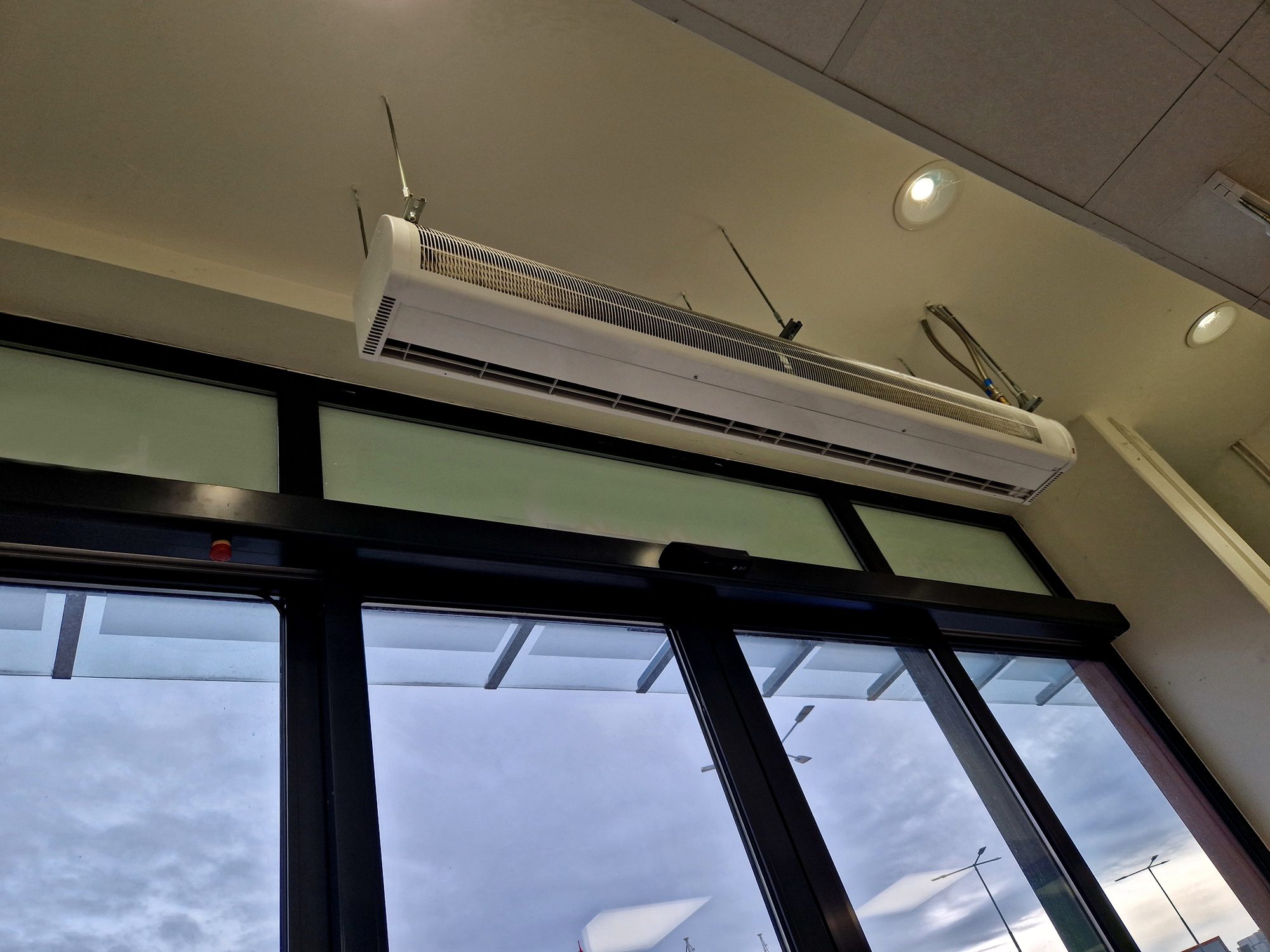 Air curtain vent above a business's entrance doors