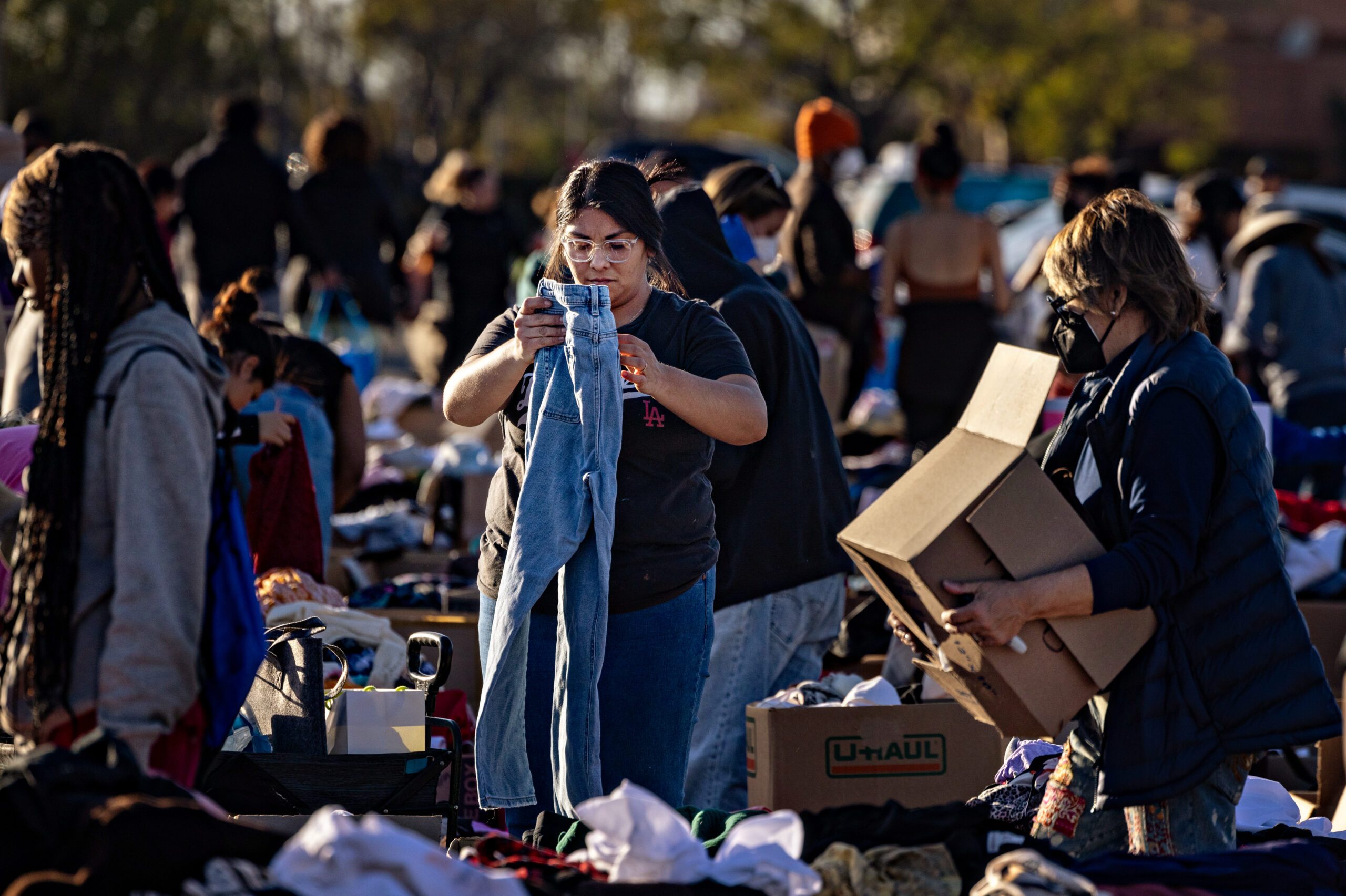 Community members stop by a donation center that has taken over the parking lot at the Santa Anita Racetrack after the Eton fire in Altadena