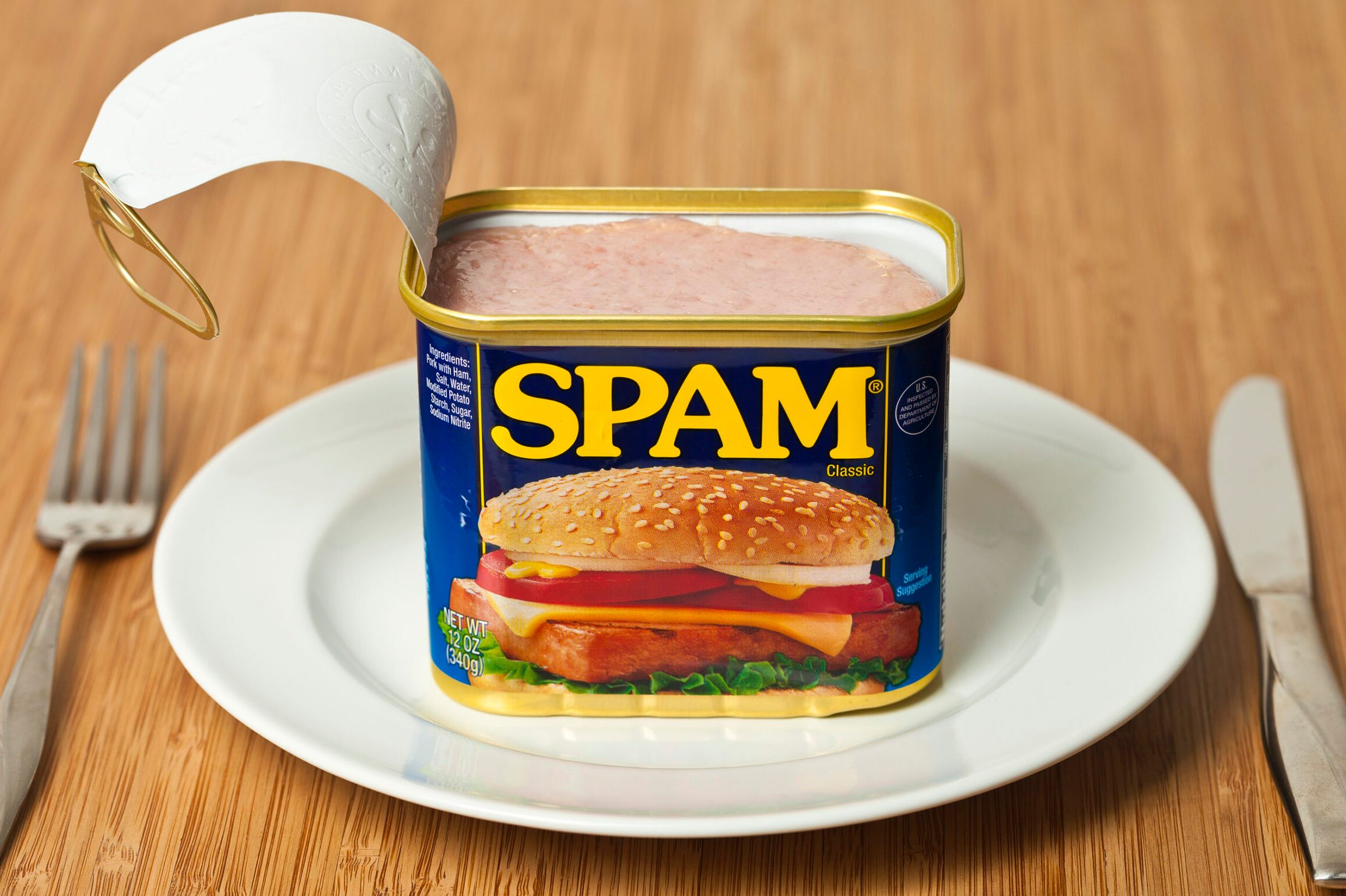 SPAM Can on a plate with fork and knife on the side
