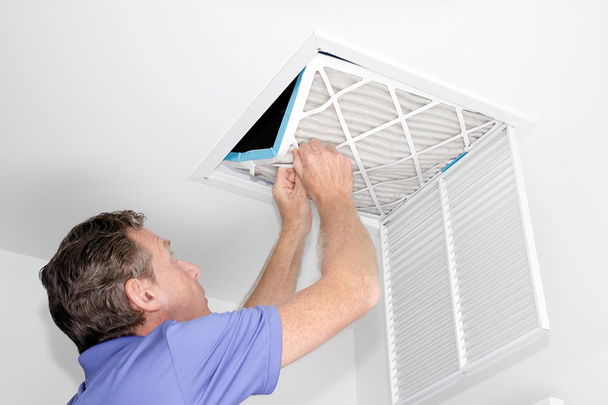 Man Removing Dirty HVAC Air Filter