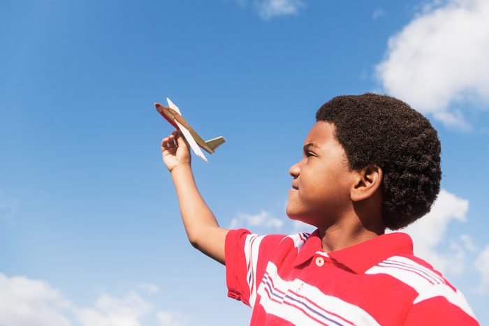 kid playing with toy airplane