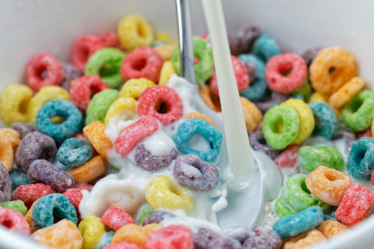 milk being poured into cereal