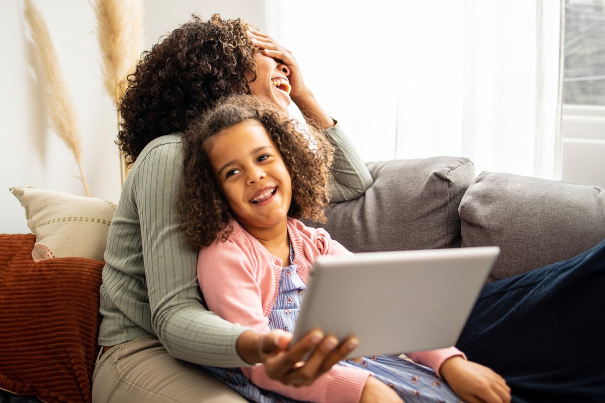 woman and daughter using an iPad