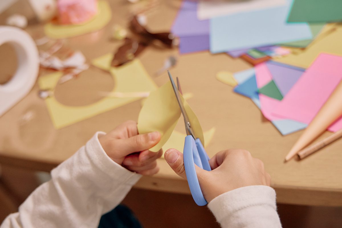 cutting construction paper into shape of an egg