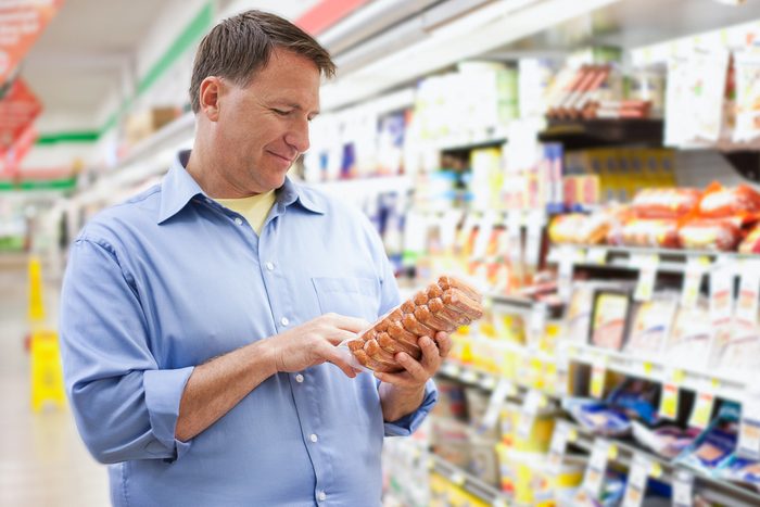 man buying hot dogs at a store