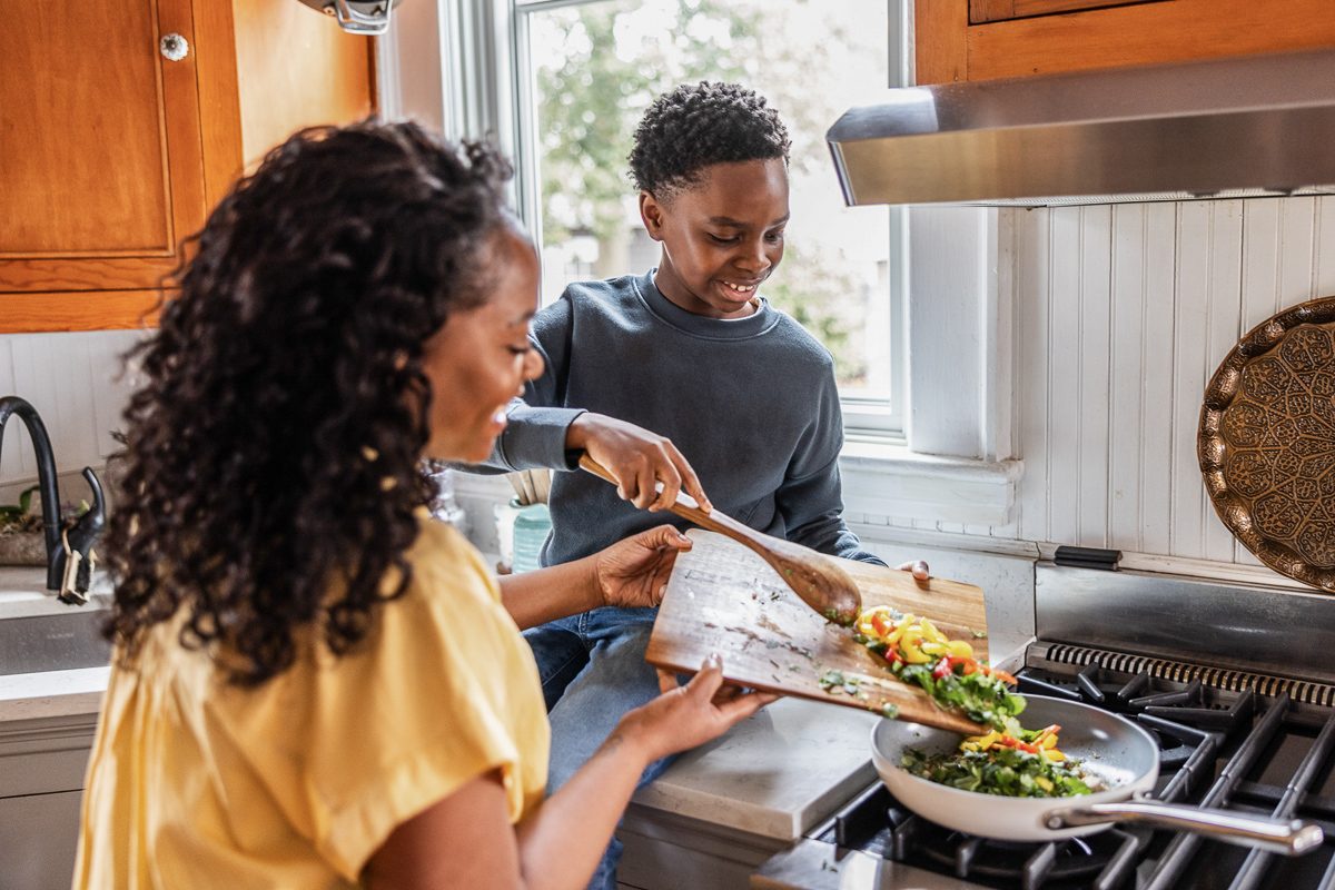 woman cooking with her son