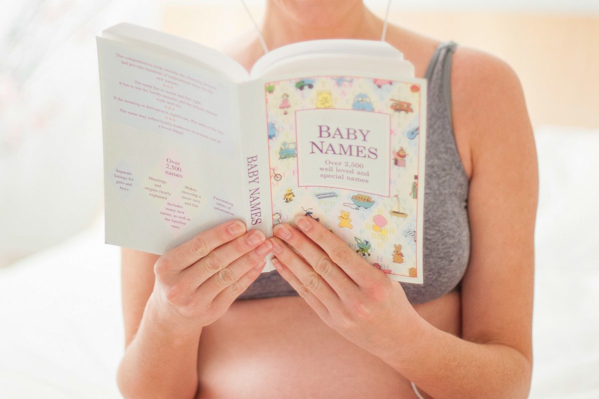 woman reading book of baby names