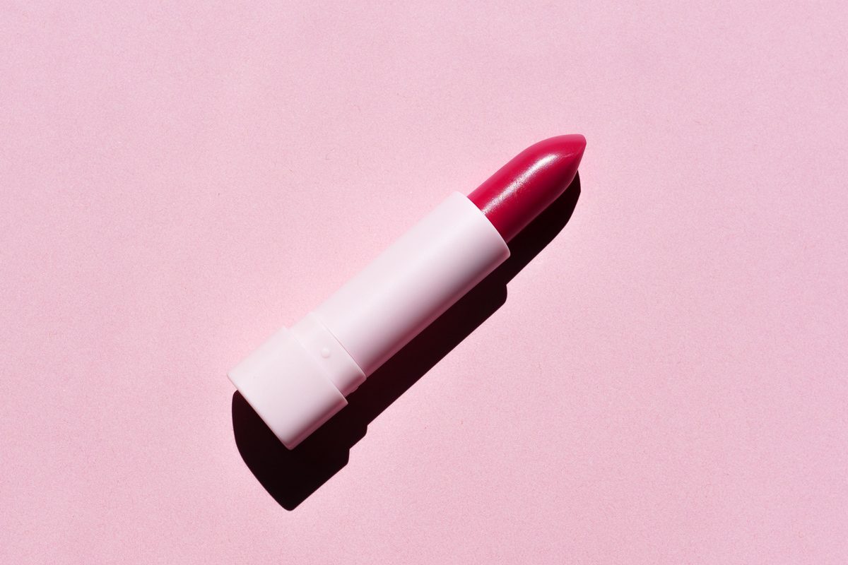 red lipstick on solid pink background
