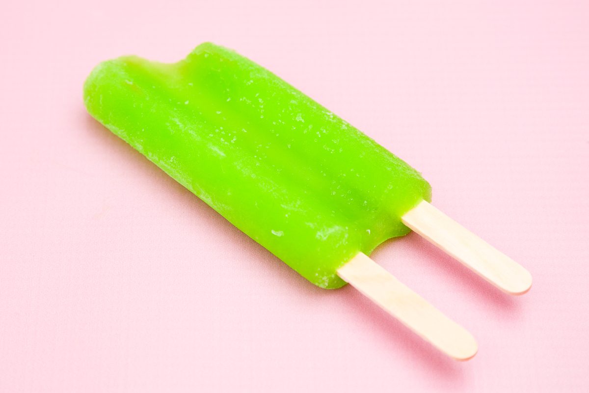 two stick popsicle on solid pink background