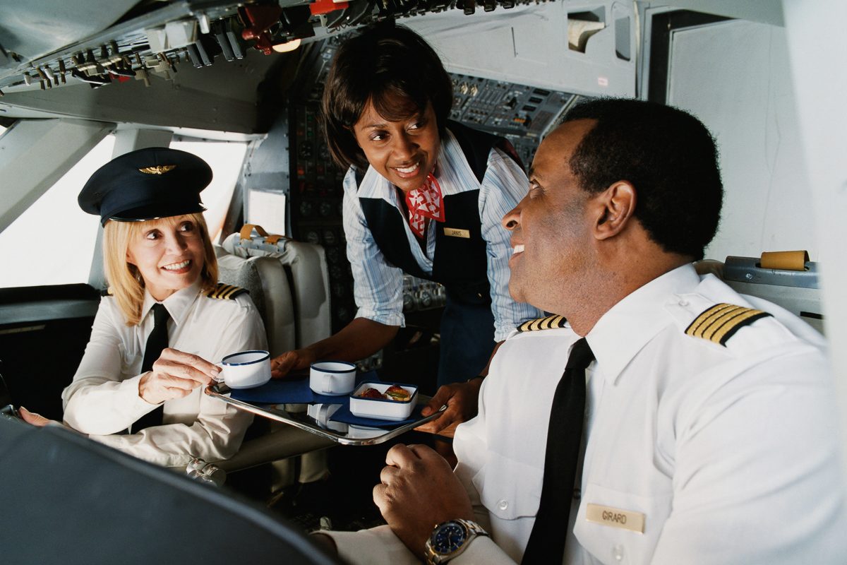 air hostess serving pilot and copilot