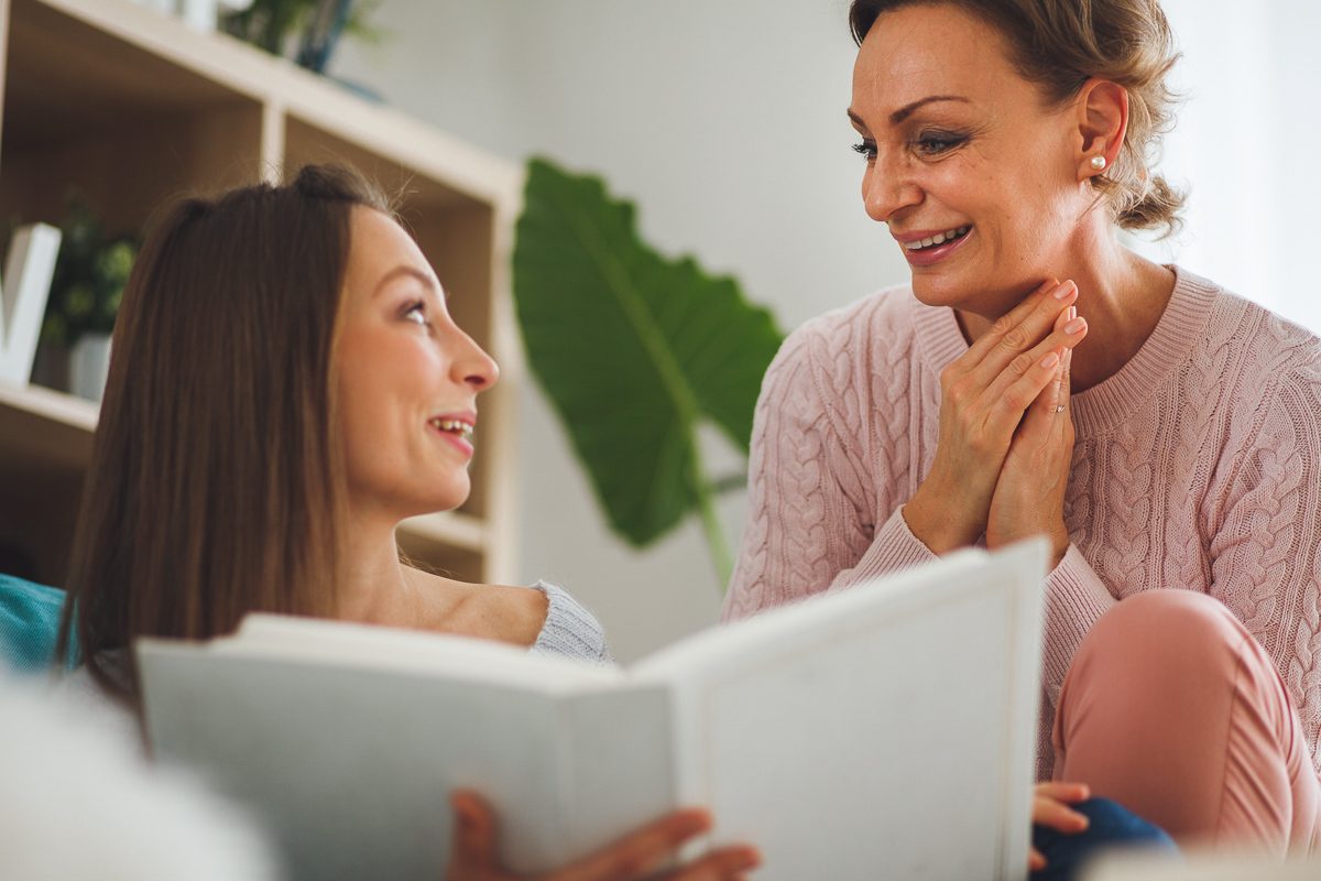 mother and daughter looking at a photo album