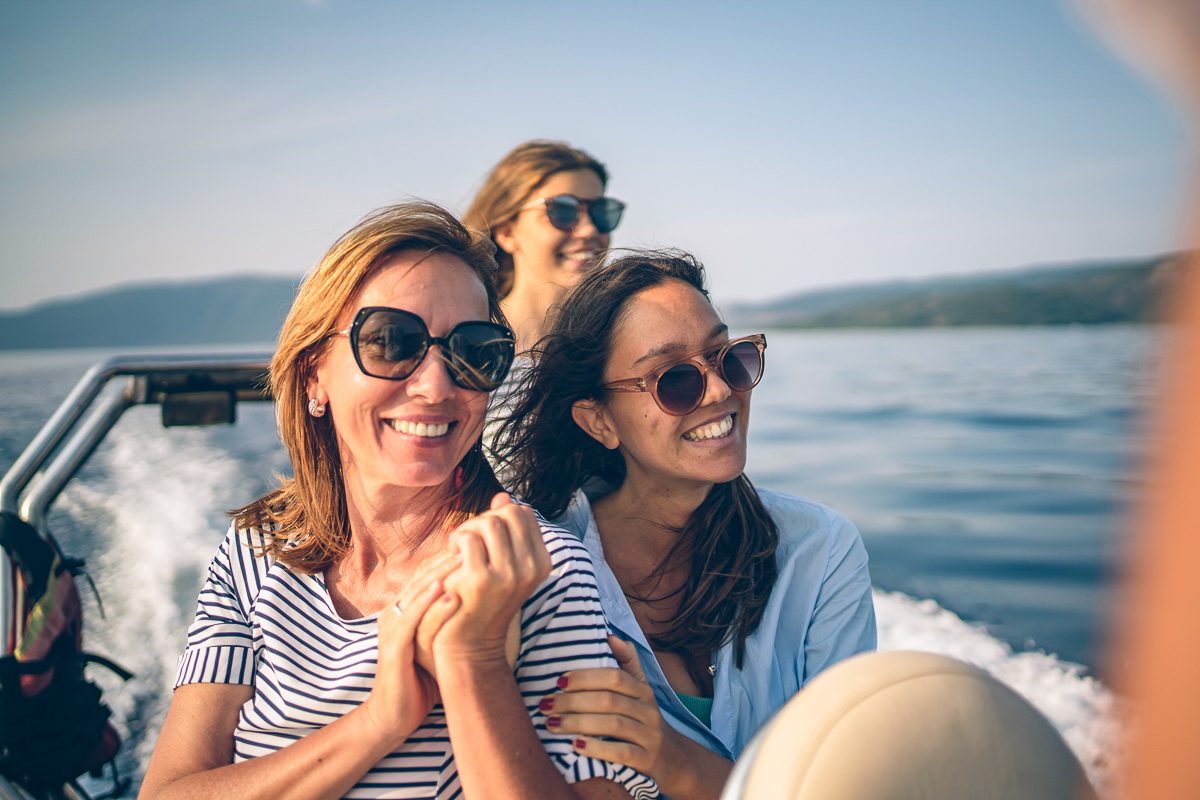 woman on a boat with daughters