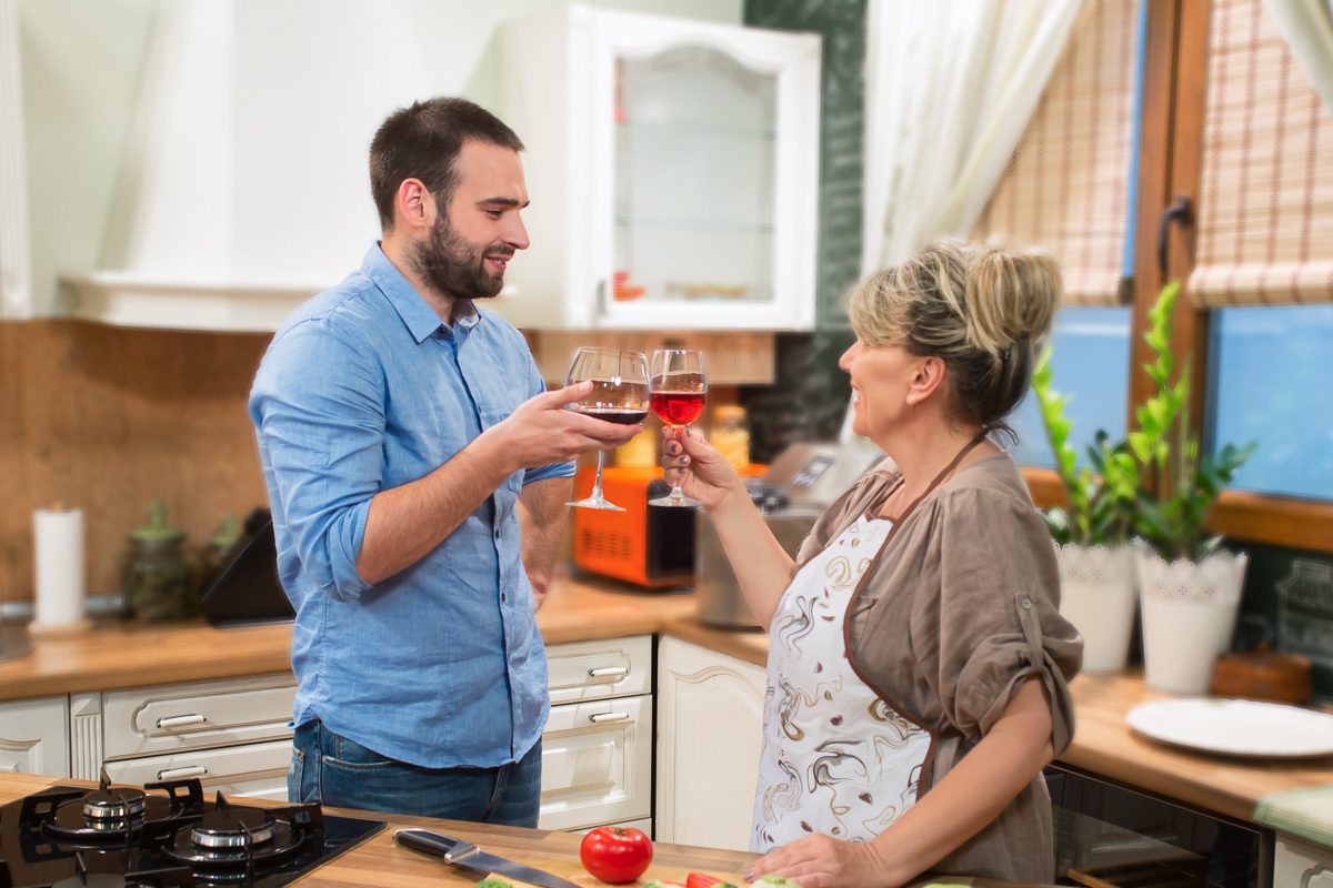 mother and son toasting with wine