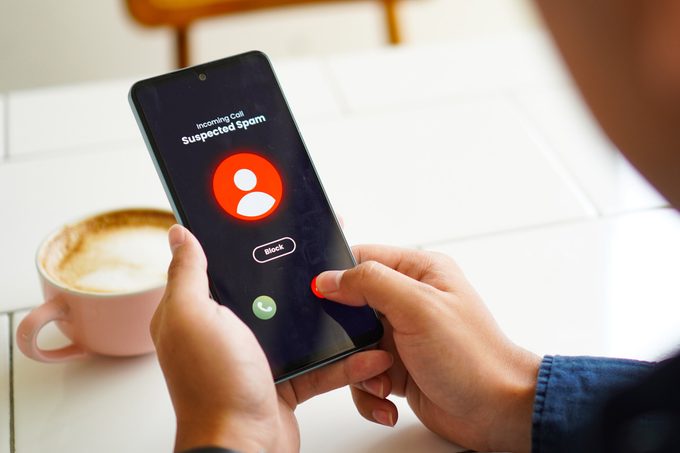 phone screen with suspected scam warning