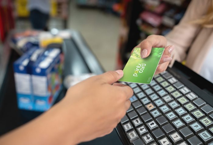 Close-up holding a rewards card at the supermarket
