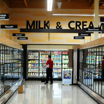 Dairy section at back of grocery store