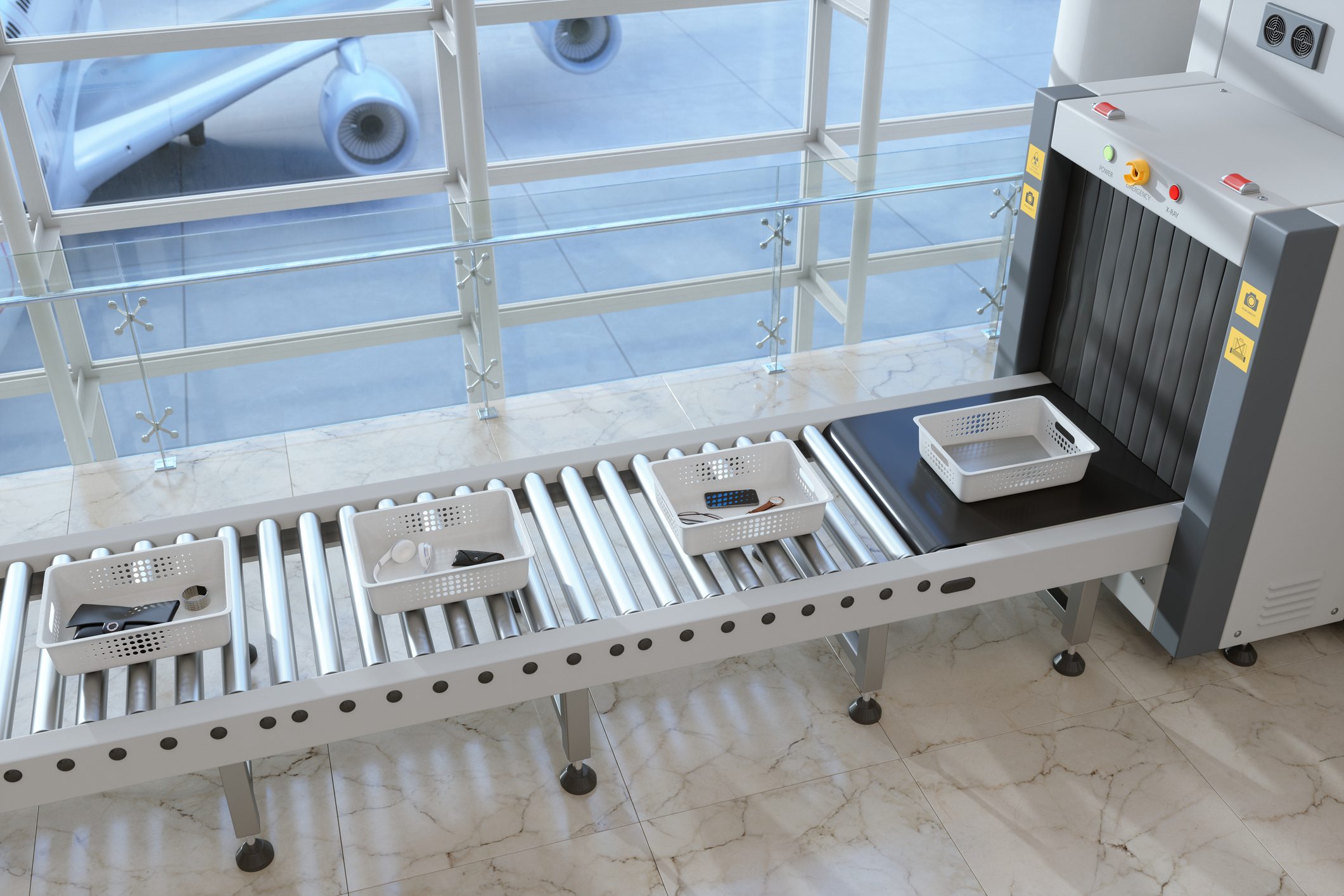 High Angle View Of Trays With Personal Belongings On Conveyor Belt At Airport Security Checkpoint