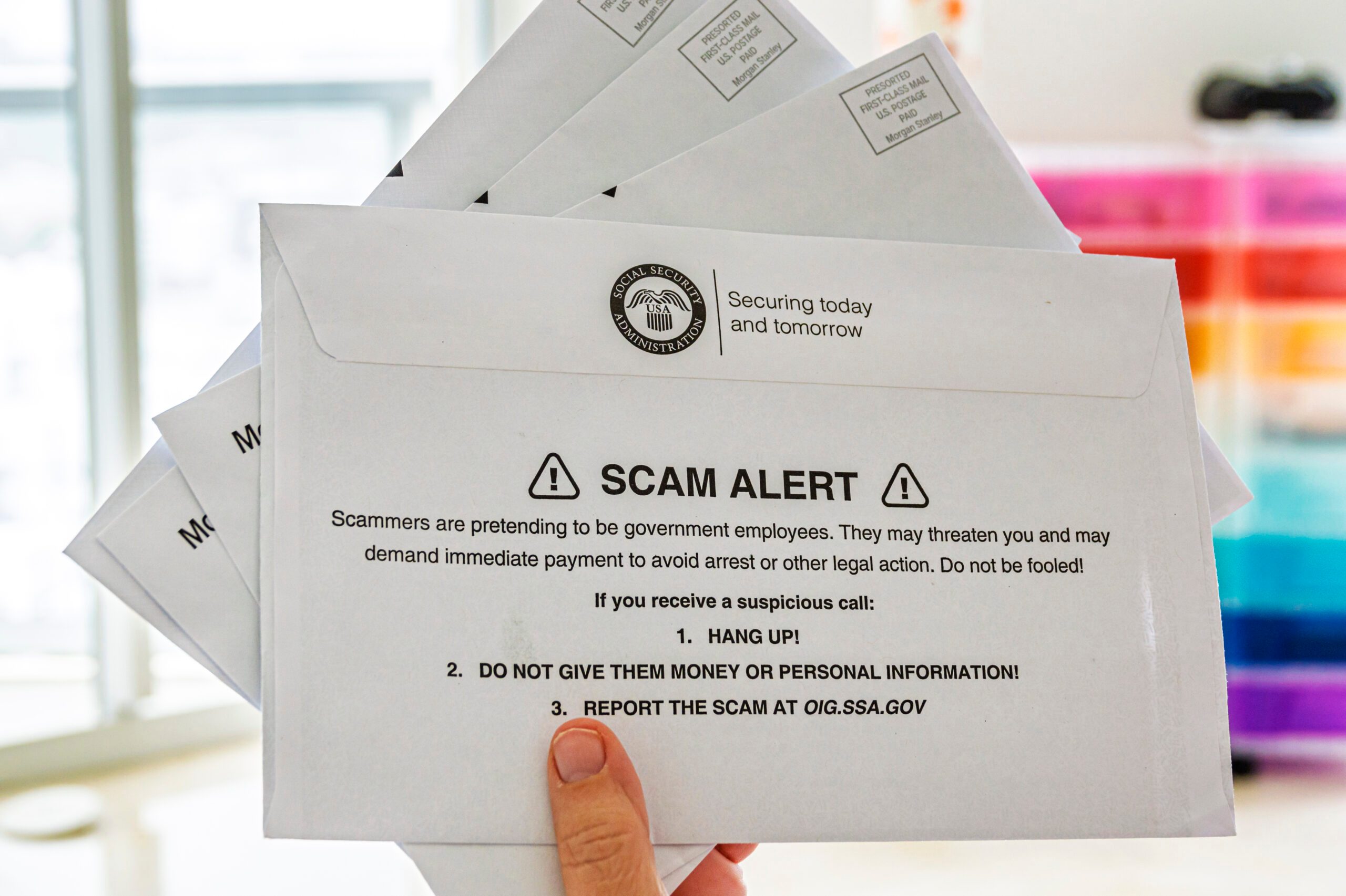hand holding, Social Security Administration, letter envelope, message warning, scam alert