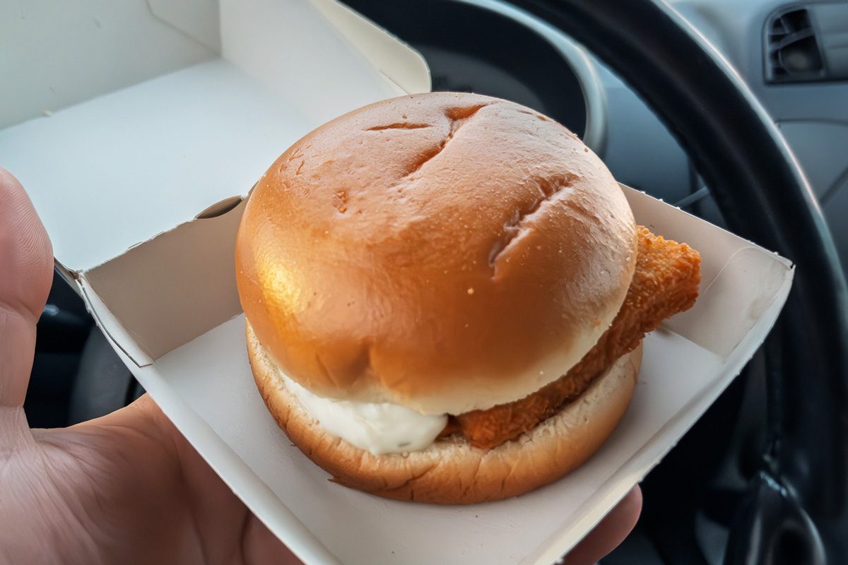Delicious Filet-O-Fish Held in Hand Inside Car