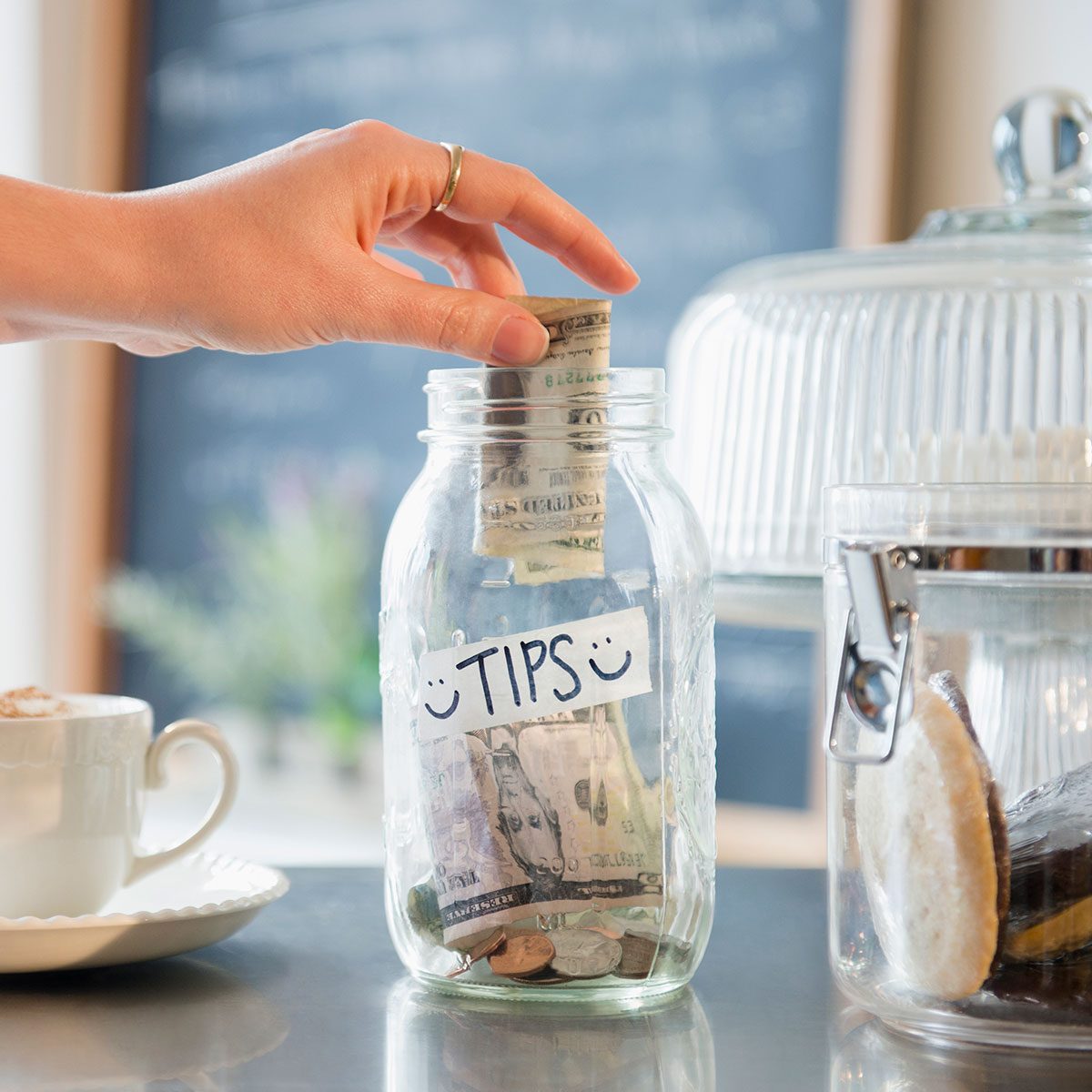 A person put money in a tip box