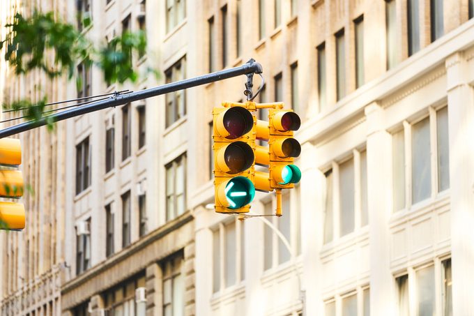 front view of a yellow traffic light hanging from a pole