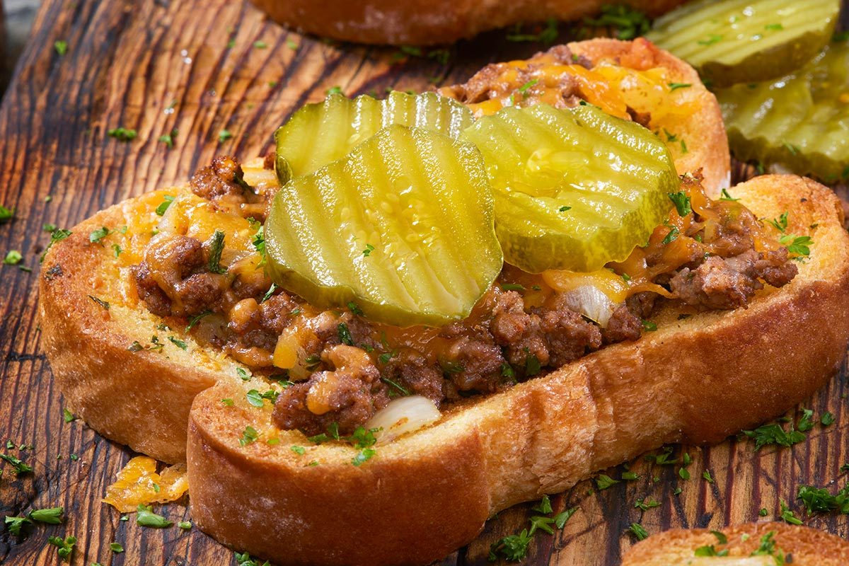 Meat sandwich with pickles on top