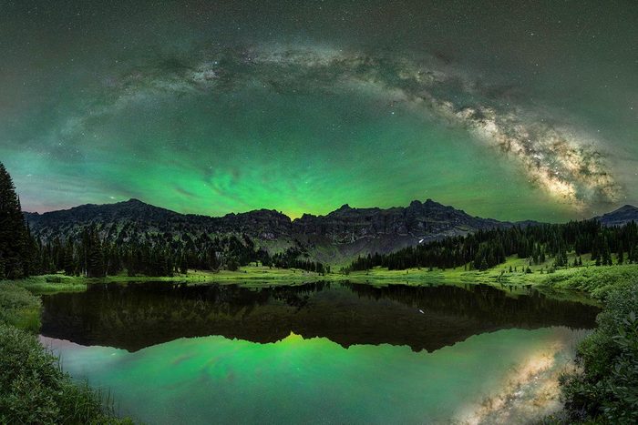Milky Way and starry sky stretch out over a mountain lake