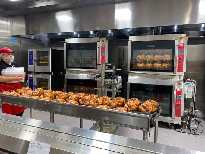 Costco employee packaging Rotisserie chickens in back of store