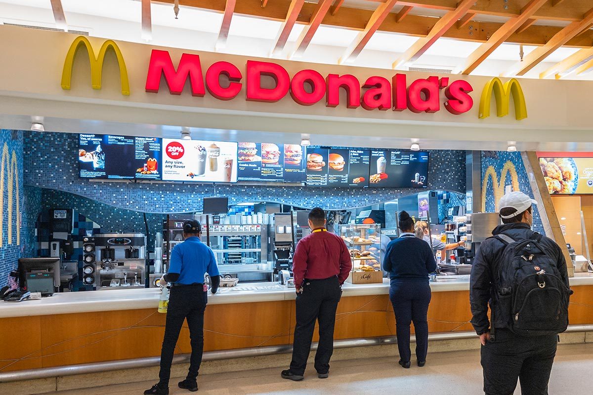 Customers byuing and paying at the mcdonald's counter