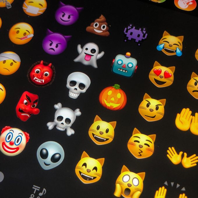 Different emojis are shown on a tablet.