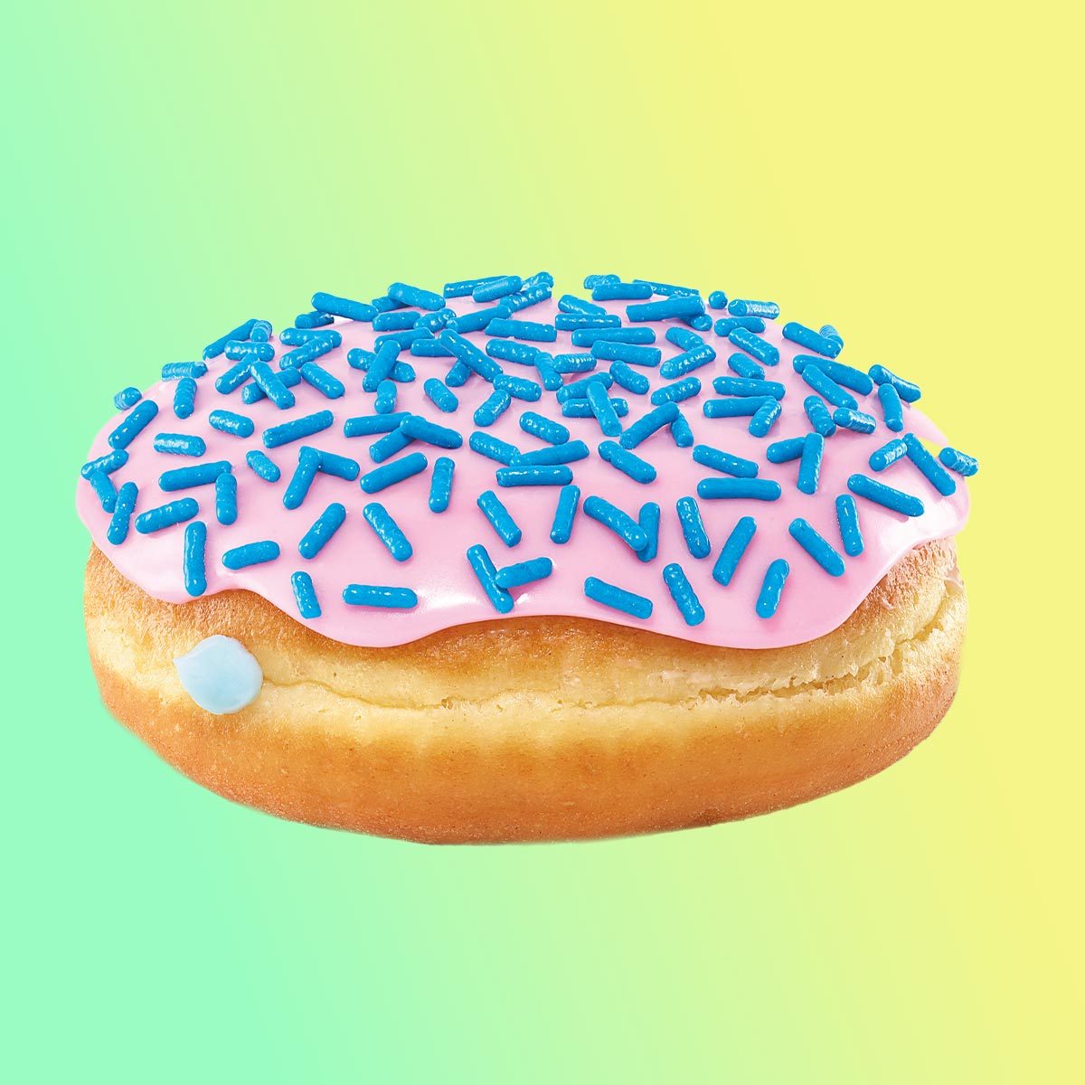Donut with cotton candy filling, pink icing and blue sprinkles on a yellow and green background
