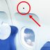Here's What That Tiny Black Triangle Above Airplane Windows Means